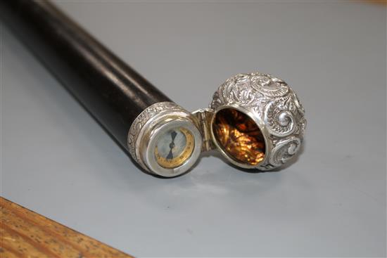 A Victorian walking stick with embossed silver pommel H.M., Birmingham 1906, opens to reveal a compass, overall length 89.5cm